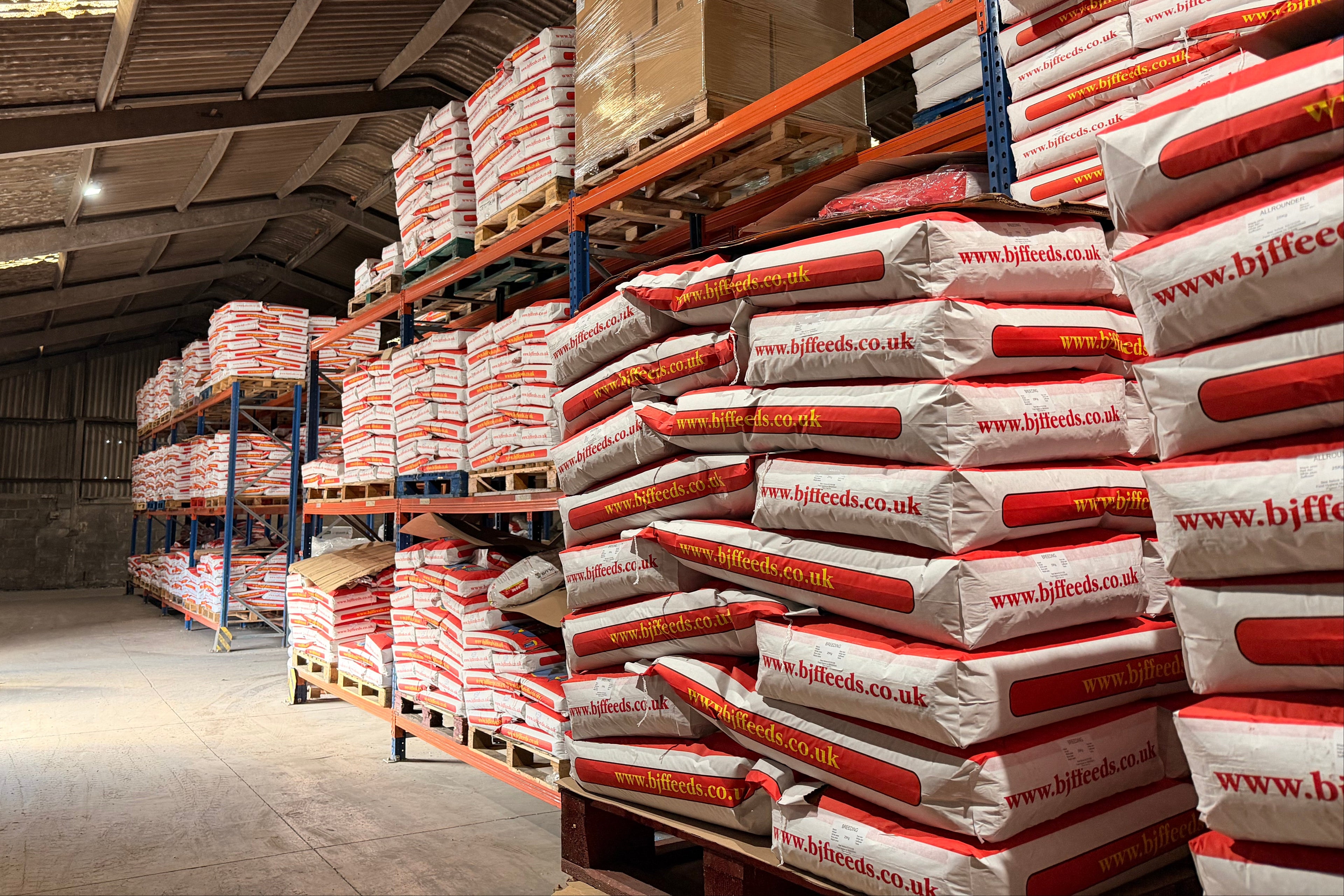 Stacks of bags with visible branding in a warehouse setting