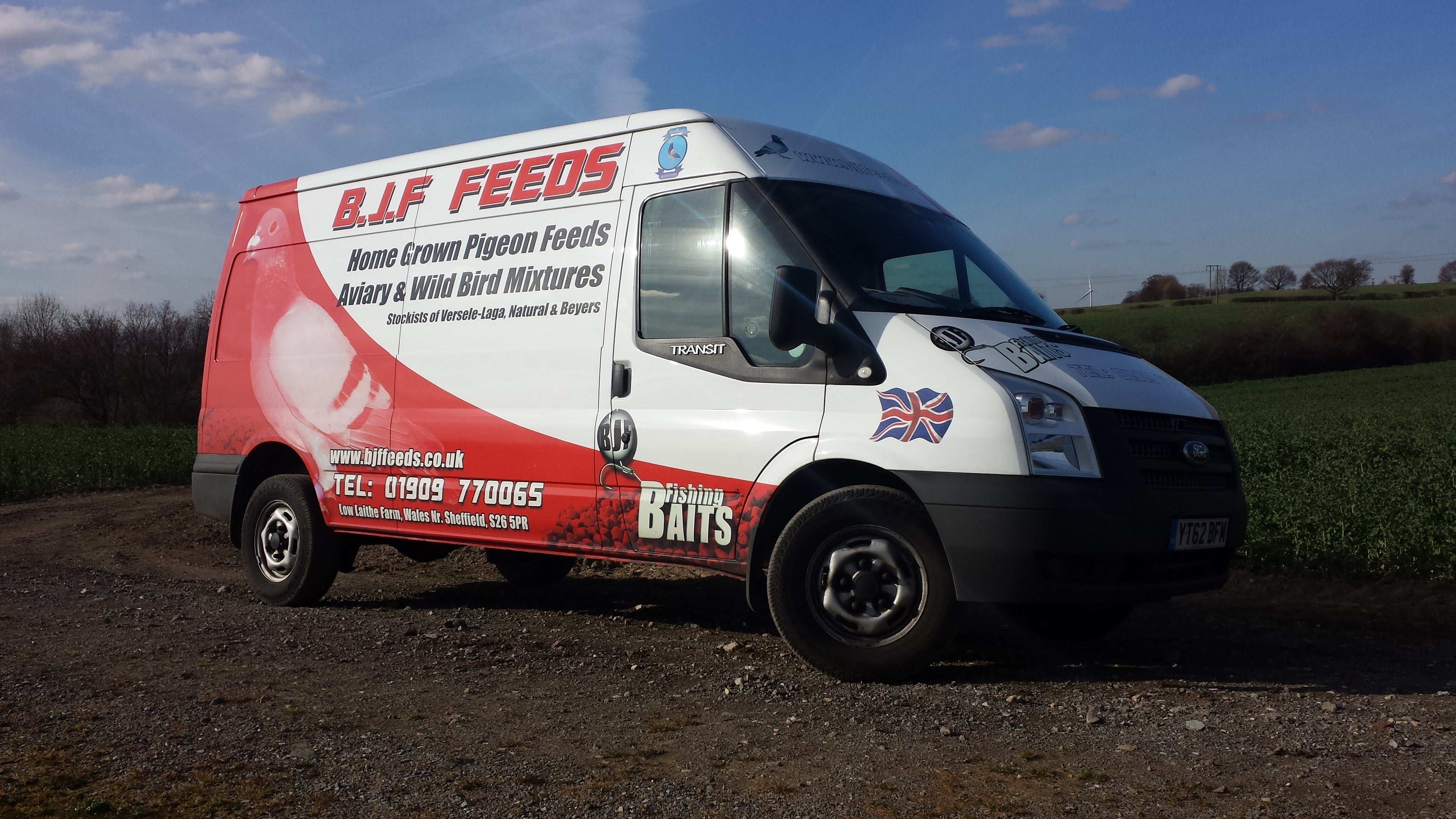 Van with B.J.F Feeds branding on a rural road